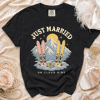 Black t-shirt with "Just Married on Cloud Nine" text, skis, and mountains graphic.
