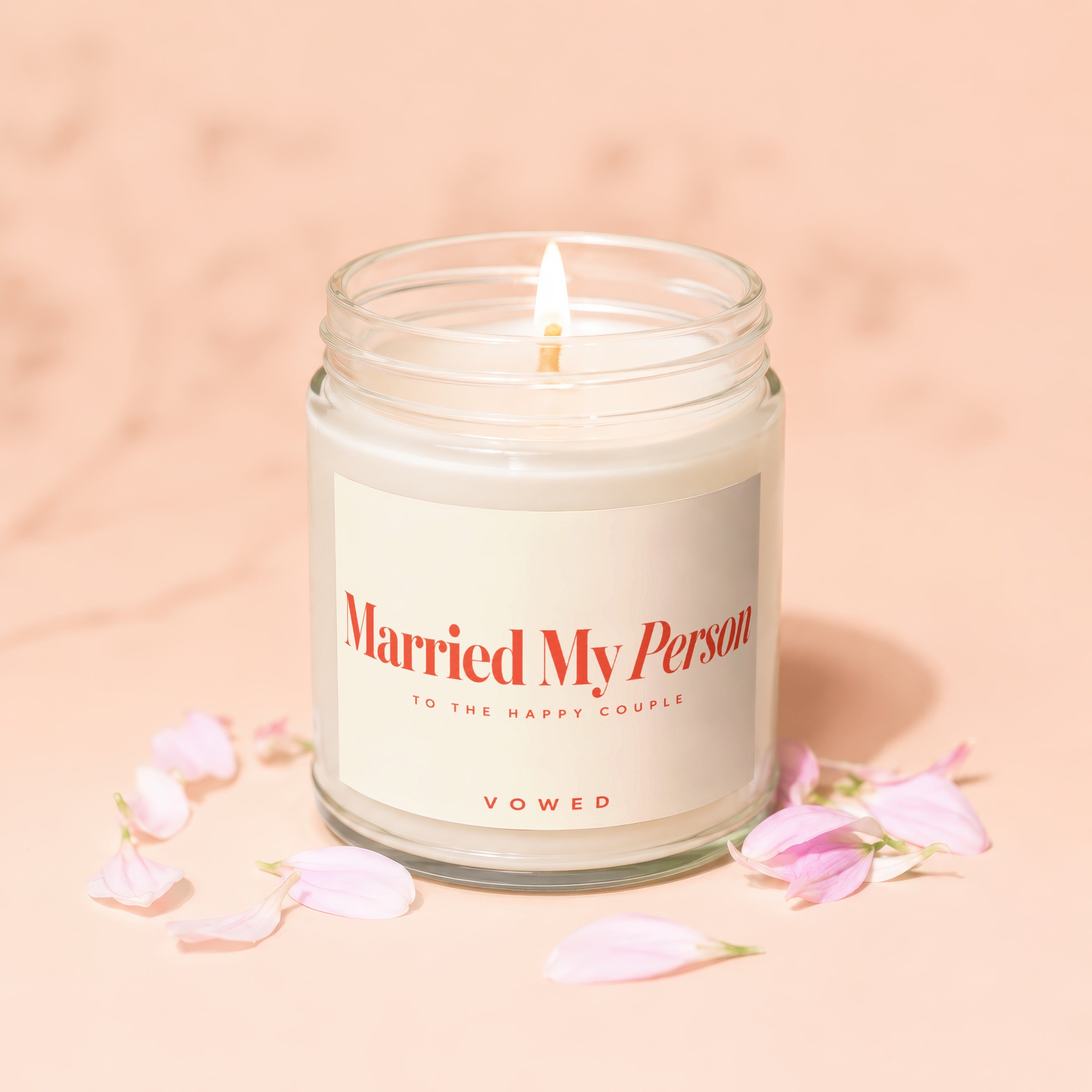 Lit candle in a jar with a label that reads "Married My Person TO THE HAPPY COUPLE" and "VOWED".