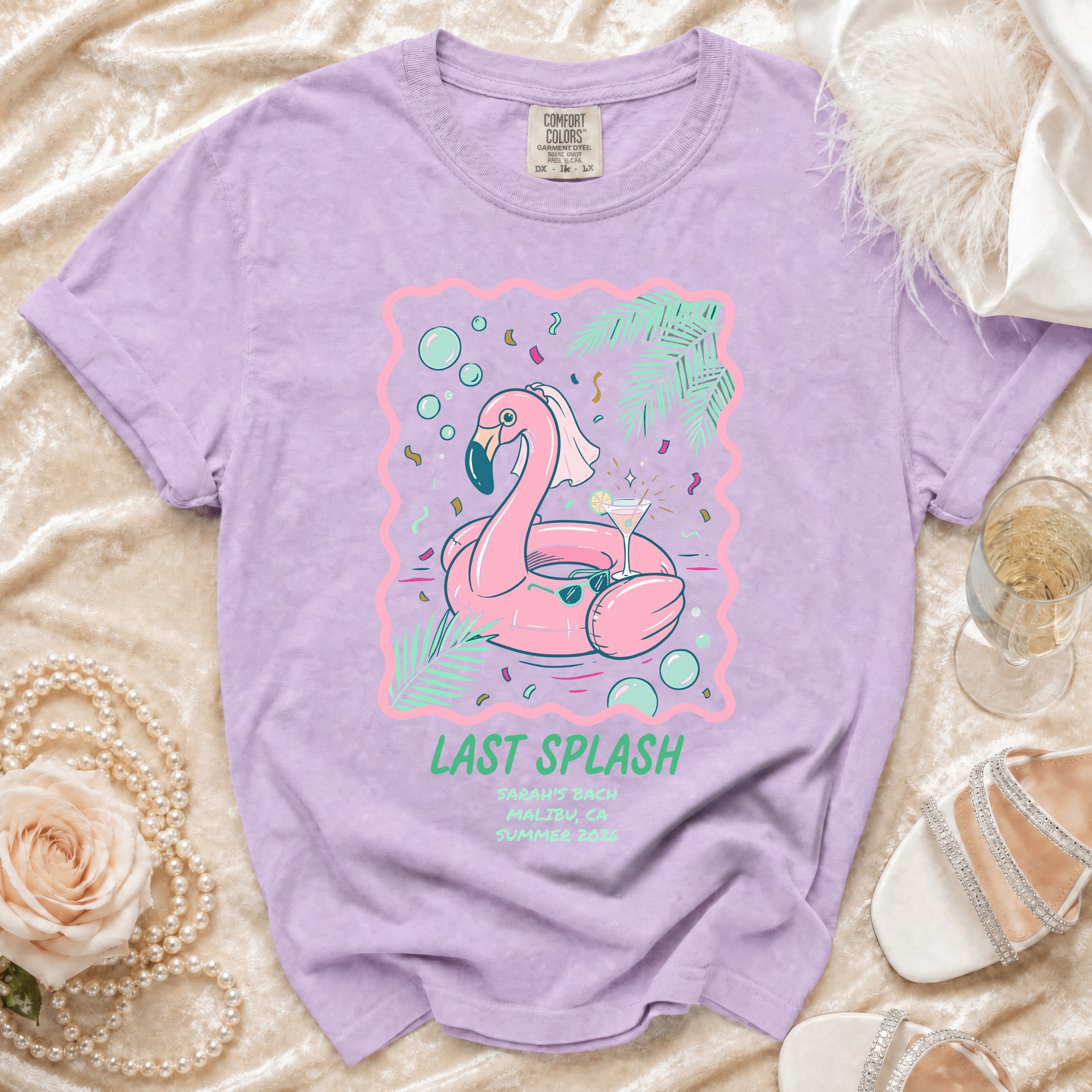 T-shirt graphic featuring a flamingo pool float, cocktails, and "Last Splash" text.