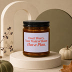 Amber jar candle with white label reading "Don't Worry, Your Maid of Honor Has a Plan."
