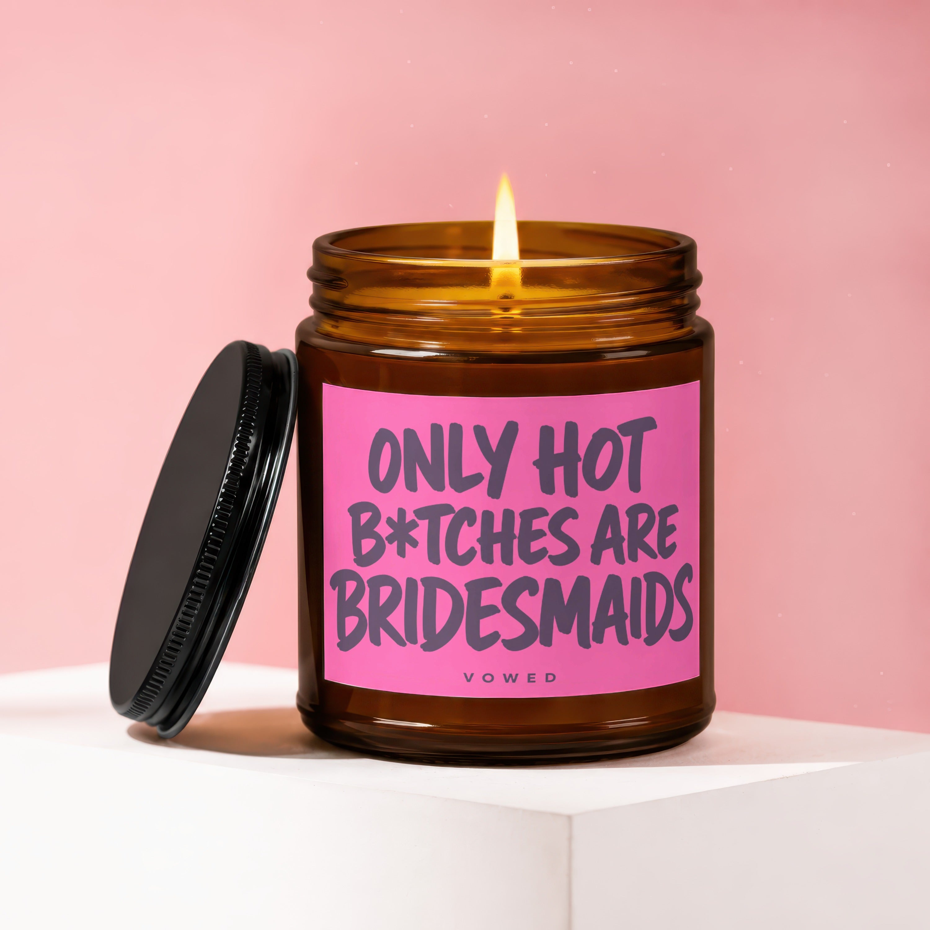 Amber jar candle with pink label reading "ONLY HOT B*TCHES ARE BRIDESMAIDS"