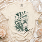 Cream t-shirt with "MILF of Honor" text, crown, bouquet, champagne glasses, and lips.