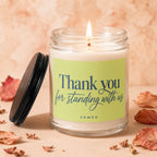 Candle with label "Thank you for standing with us VOWED" on a warm background.