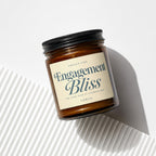 Amber glass candle with "Engagement Bliss" label and "Vowed" scent.