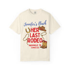 Cream t-shirt with "Jennifer's Bach Her Last Rodeo" text, horseshoe, and cowboy boots.