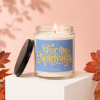Jar candle with lit wick, blue label reads "For the Newlyweds VOWED".