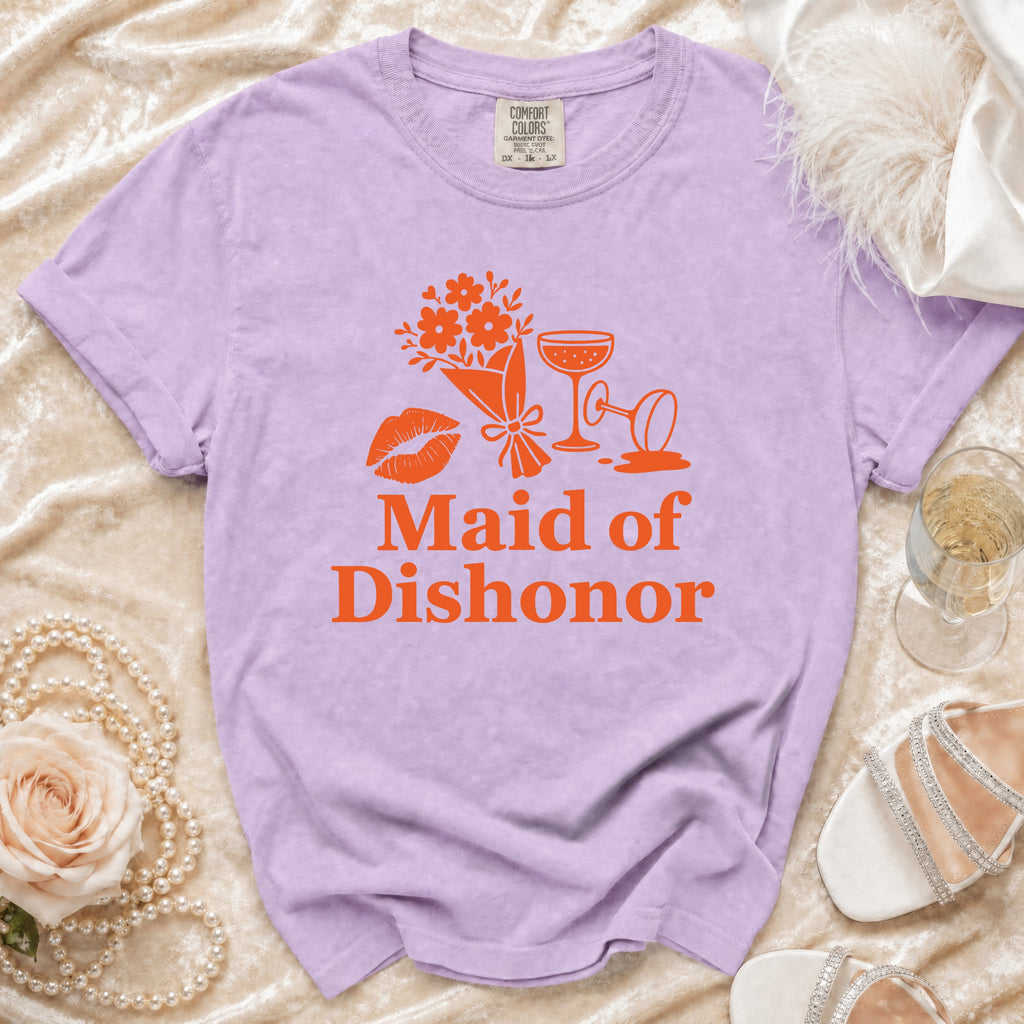 Purple t-shirt with orange text "Maid of Dishonor," lips, flowers, and champagne glasses.