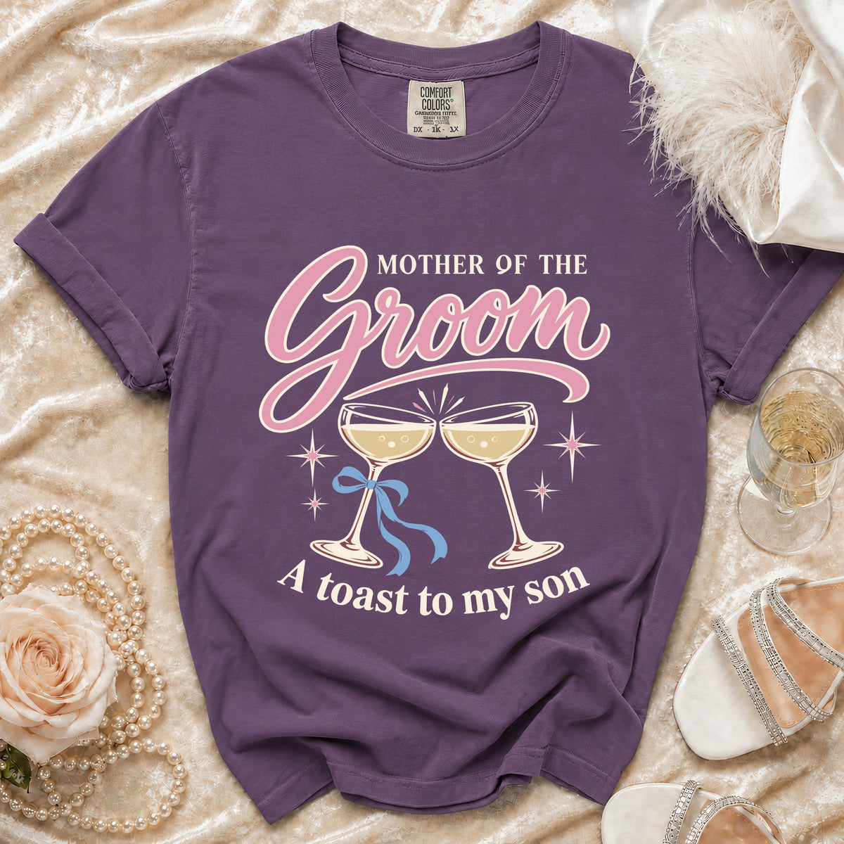 Purple t-shirt with "Mother of the Groom, A toast to my son" graphic.