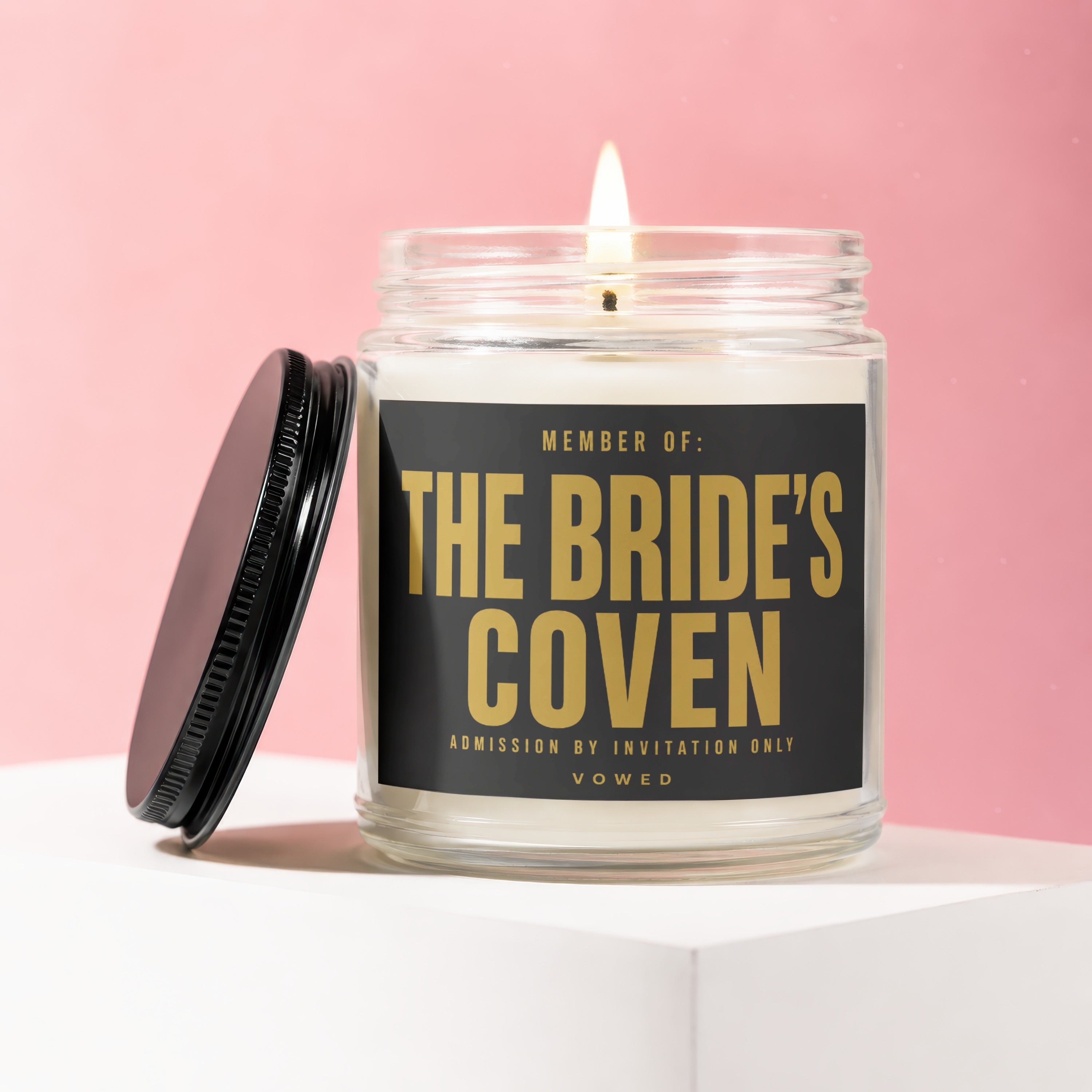 Glass candle with text "Member of: The Bride's Coven Admission by Invitation Only Vowed".