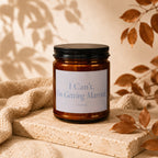 Candle with text "I Can't, I'm Getting Married" and "Vowed" on a stone block with autumn leaves.