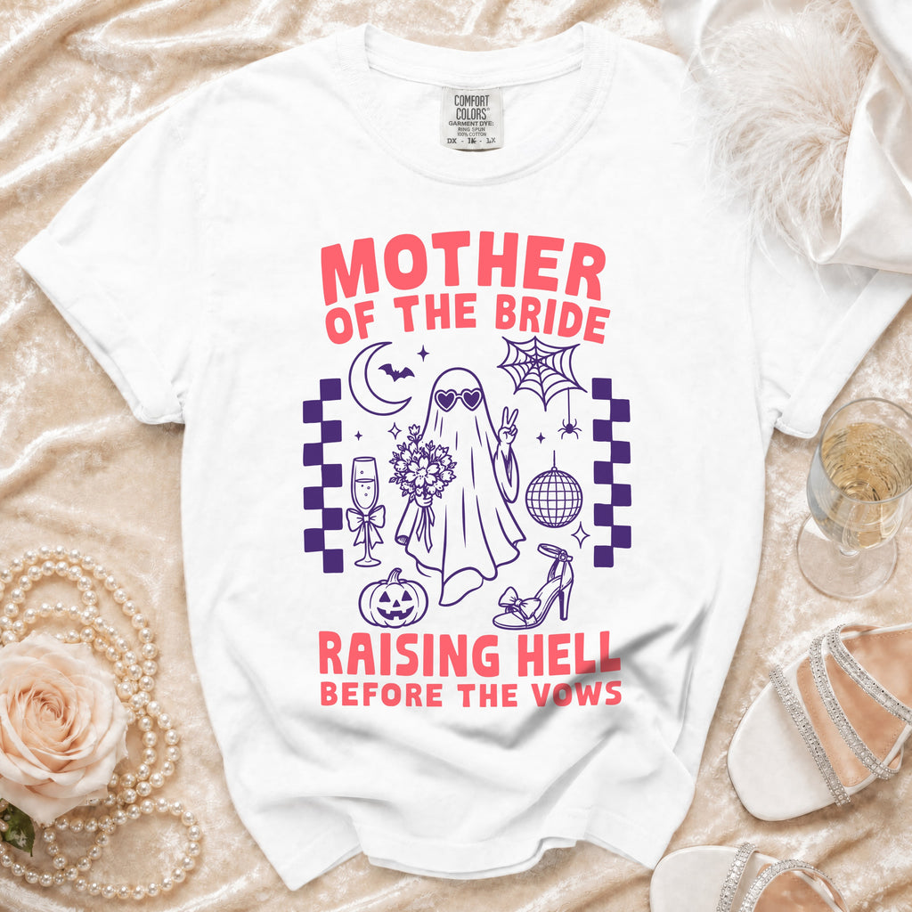 White t-shirt with "Mother of the Bride Raising Hell Before the Vows" graphic.