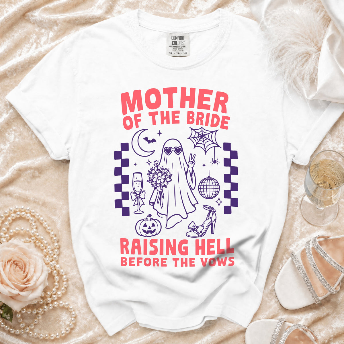 White t-shirt with "Mother of the Bride Raising Hell Before the Vows" graphic.
