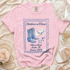 Pink t-shirt with "Reckless in Texas" and Western graphics.