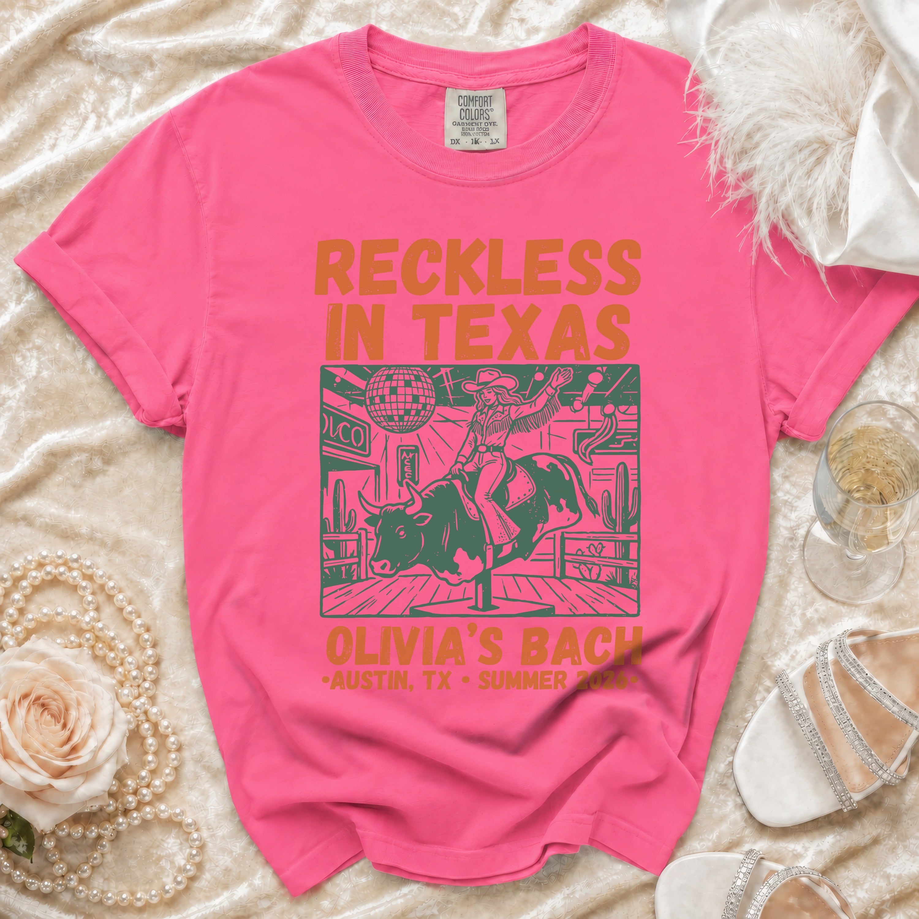 Graphic t-shirt with "Reckless in Texas" and bull rider design.