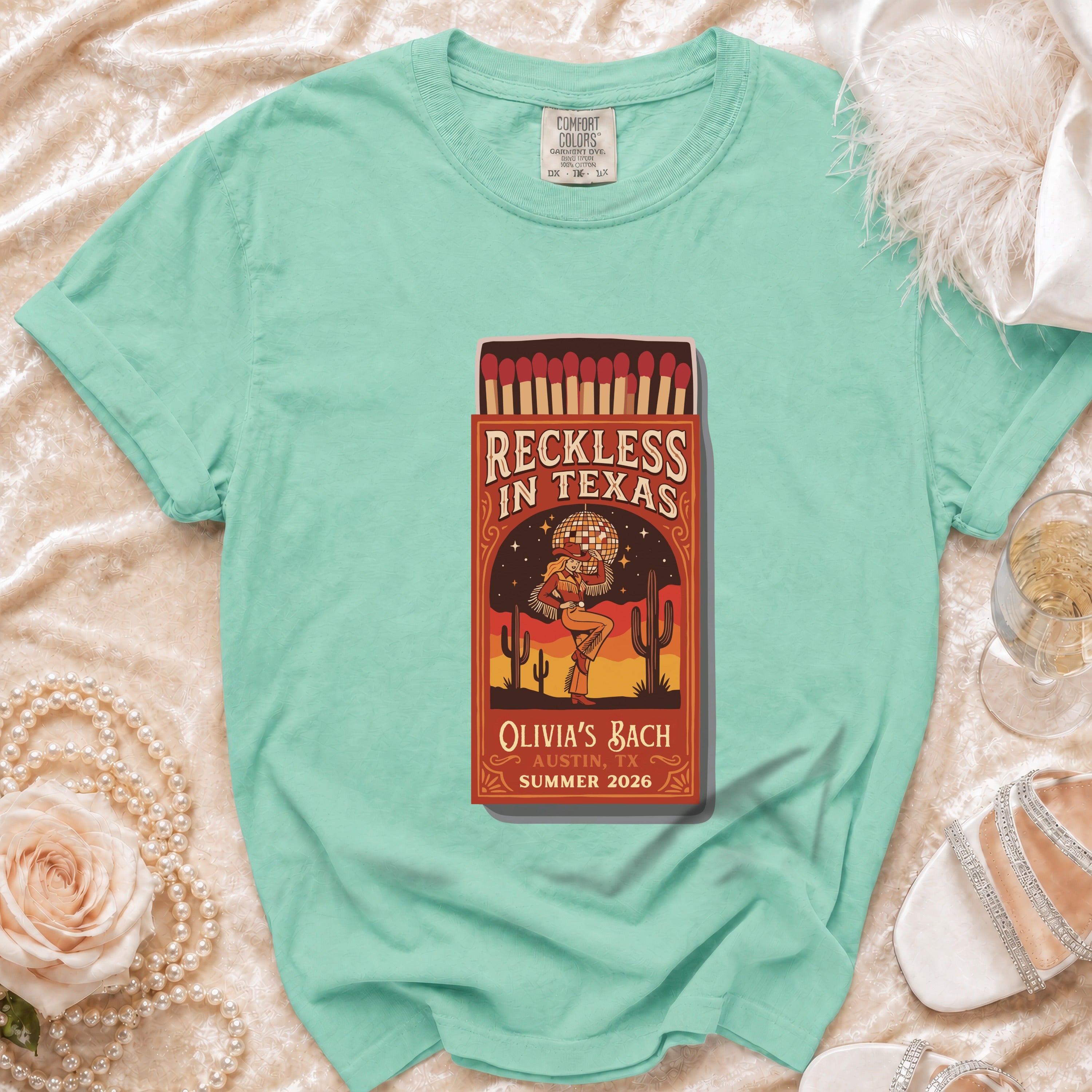 T-shirt with "Reckless in Texas" design, Olivia's Bach, Austin, TX, Summer 2026.