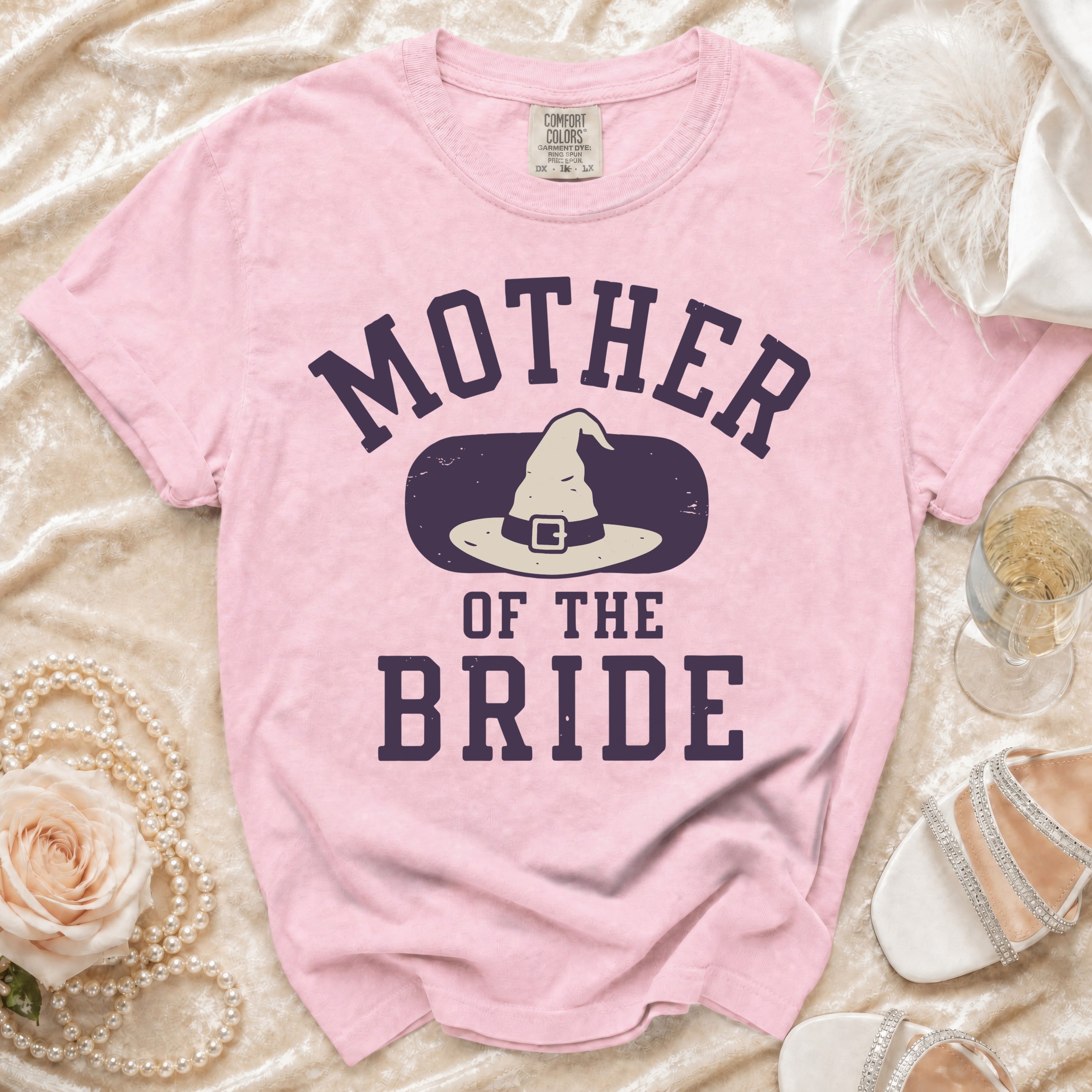 Pink t-shirt with "MOTHER OF THE BRIDE" and a witch hat graphic.