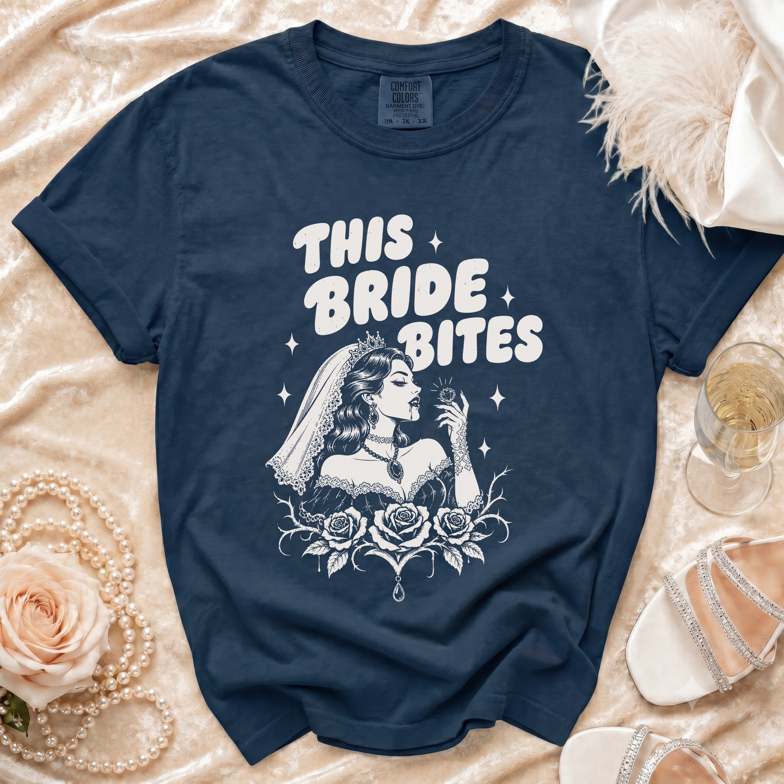 Navy t-shirt with "THIS BRIDE BITES" text and gothic bride illustration.