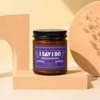 Amber jar candle with black lid labeled "I SAY I DO BRIDESMAID WANTED".