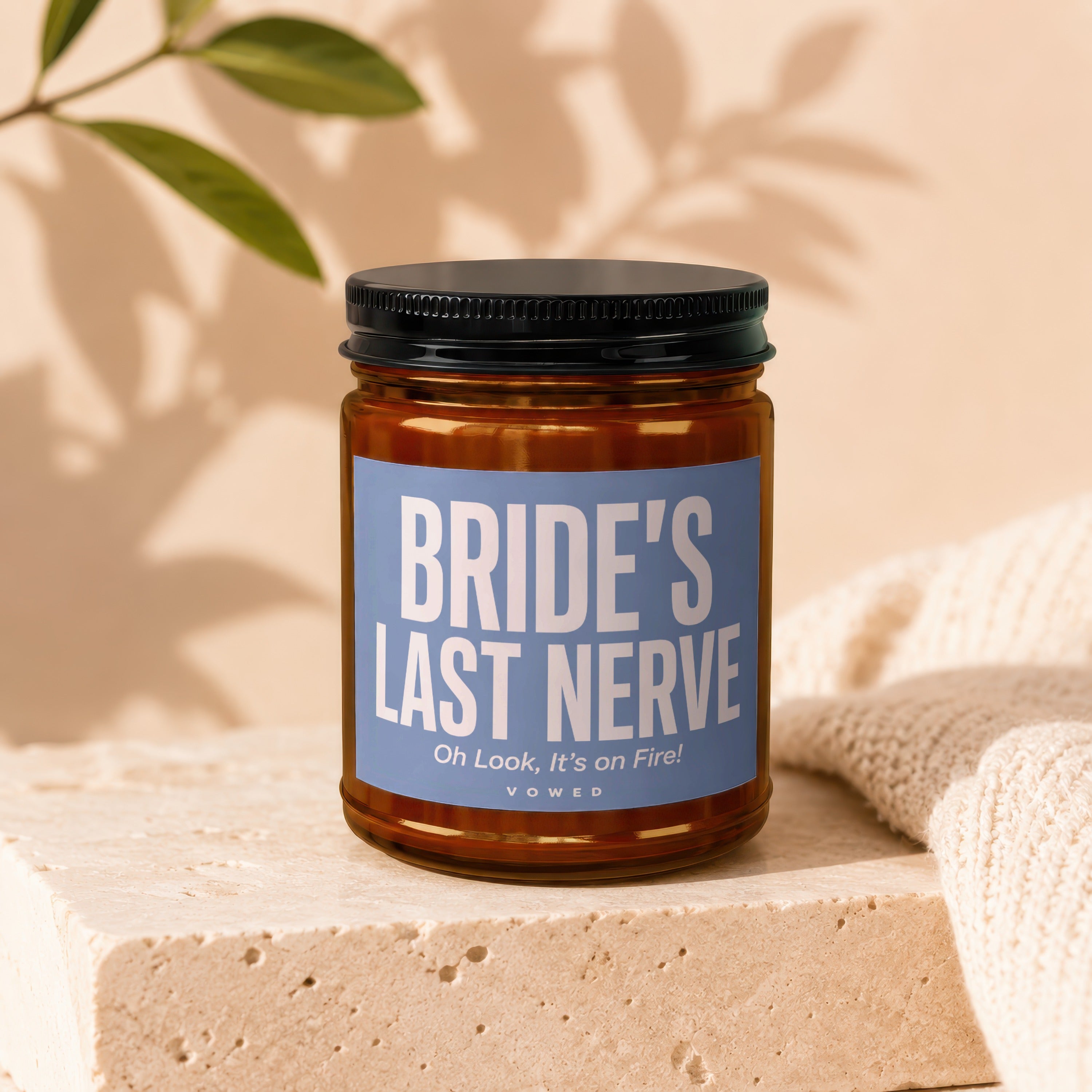 Amber candle in glass jar with black lid, label says "Bride's Last Nerve".