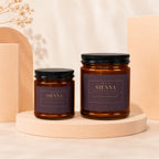 Two amber glass candles with purple labels asking "Will you be my bridesmaid?".
