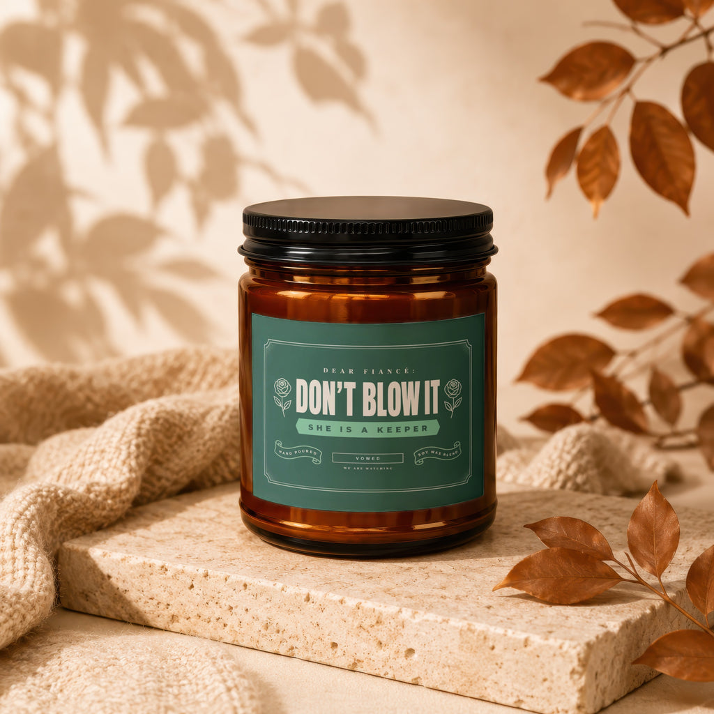 Amber jar candle with "Don't Blow It She Is A Keeper" label.