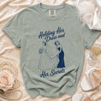 T-shirt with "Holding Her Dress and Her Secrets" design of two women.