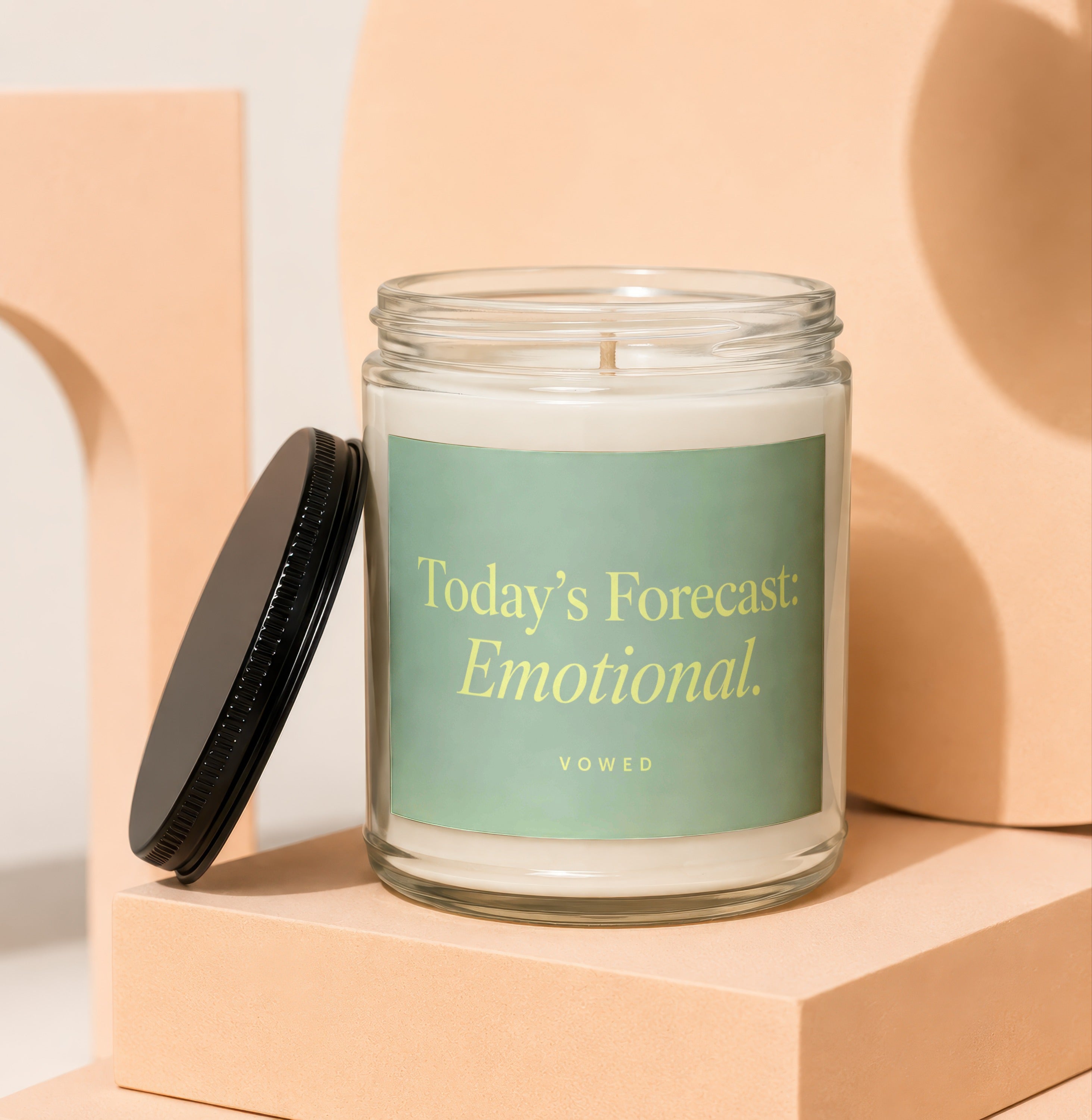 Glass candle with "Today's Forecast: Emotional." text on a mint green label.