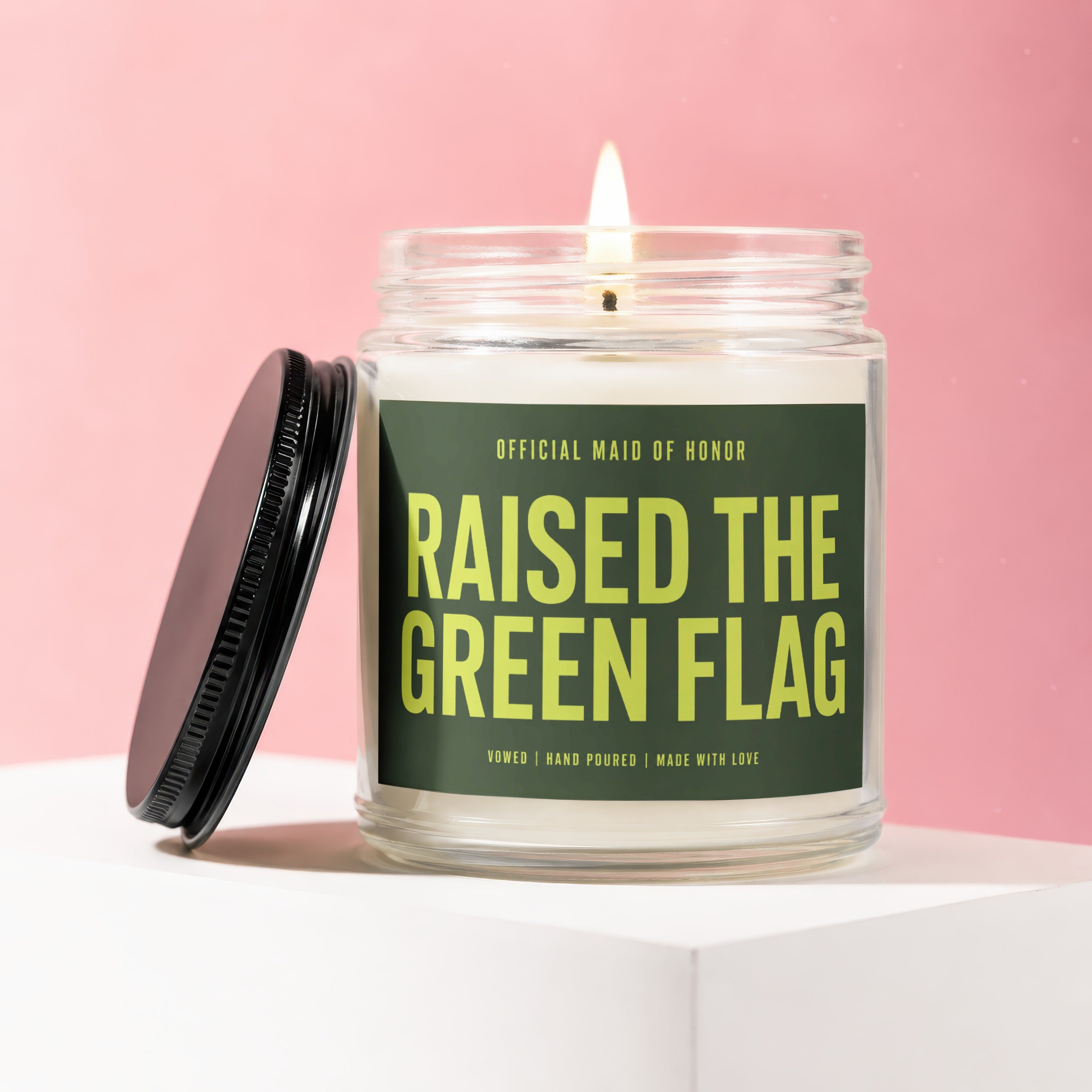 Candle with text "OFFICIAL MAID OF HONOR RAISED THE GREEN FLAG"