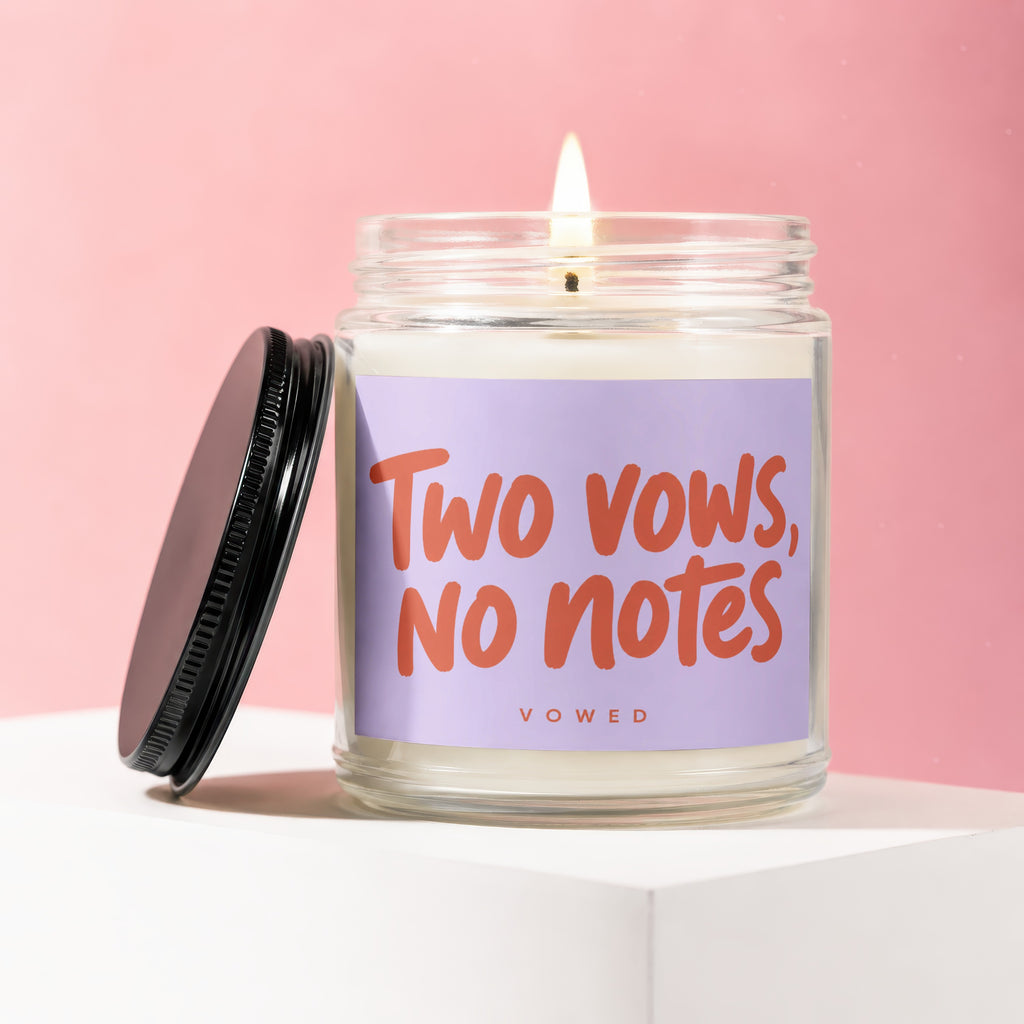 Candle with "Two vows, no notes" text on a lavender label.