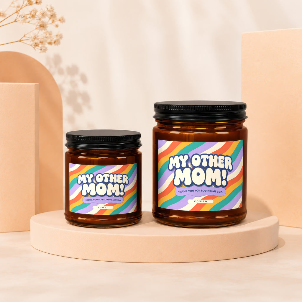 Two amber glass candles with black lids, labeled "My Other Mom!".