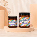 Two amber glass candles with black lids, labeled "My Other Mom!".