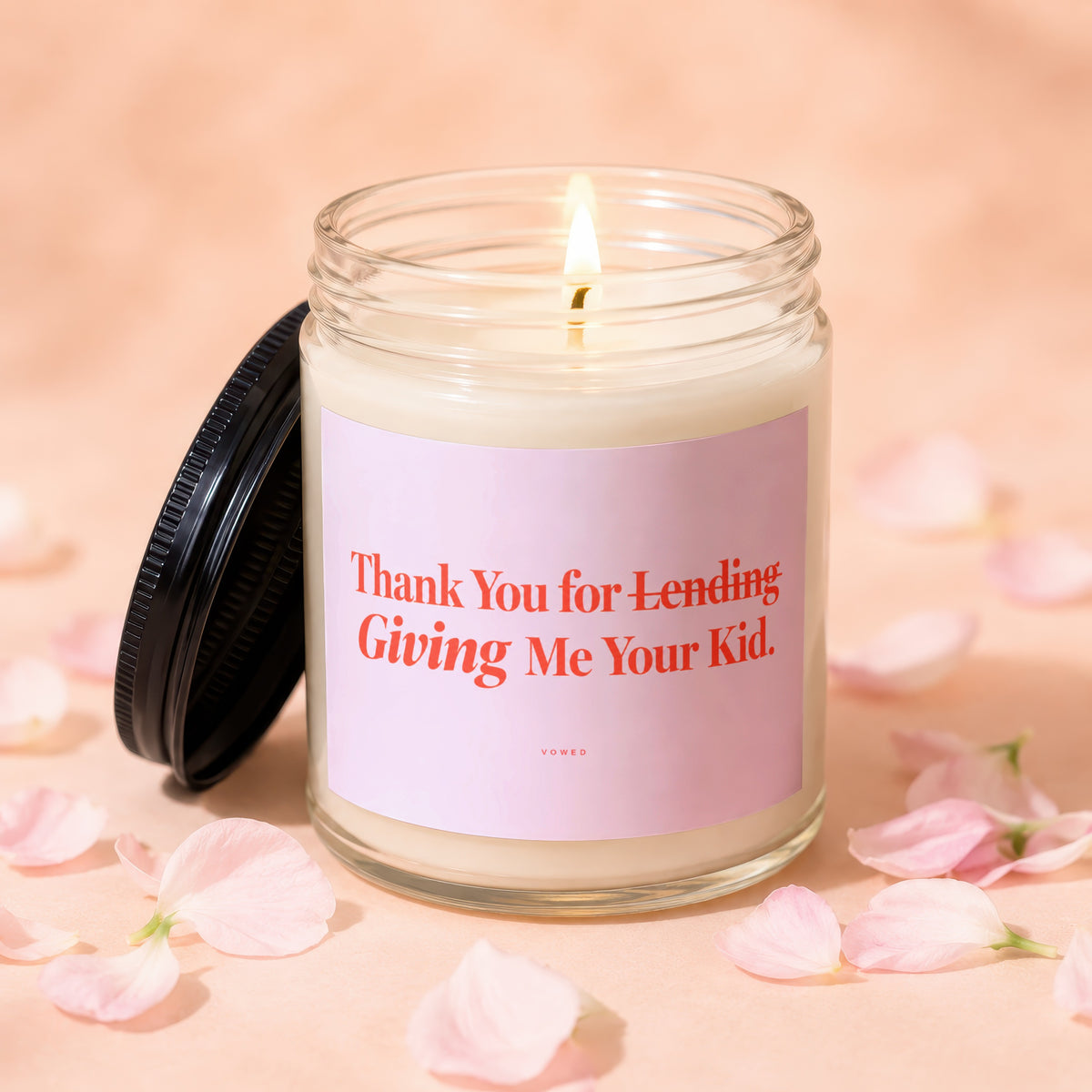 Candle with pink label reading "Thank You for Lending Giving Me Your Kid."