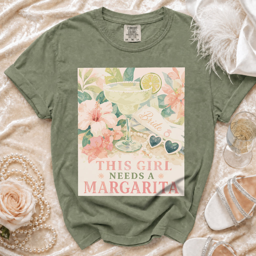 Green t-shirt with watercolor graphic of a margarita, flowers, and text "This Girl Needs a Margarita".