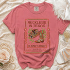 Pink t-shirt with "Reckless in Texas" and "Olivia's Bach Austin, TX Summer 2026" text.