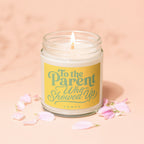 Lit candle with yellow label reading "To the Parent Who Showed Up"