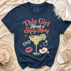 Navy t-shirt with "This Girl Needs a Spicy Marg" graphic and festive icons.