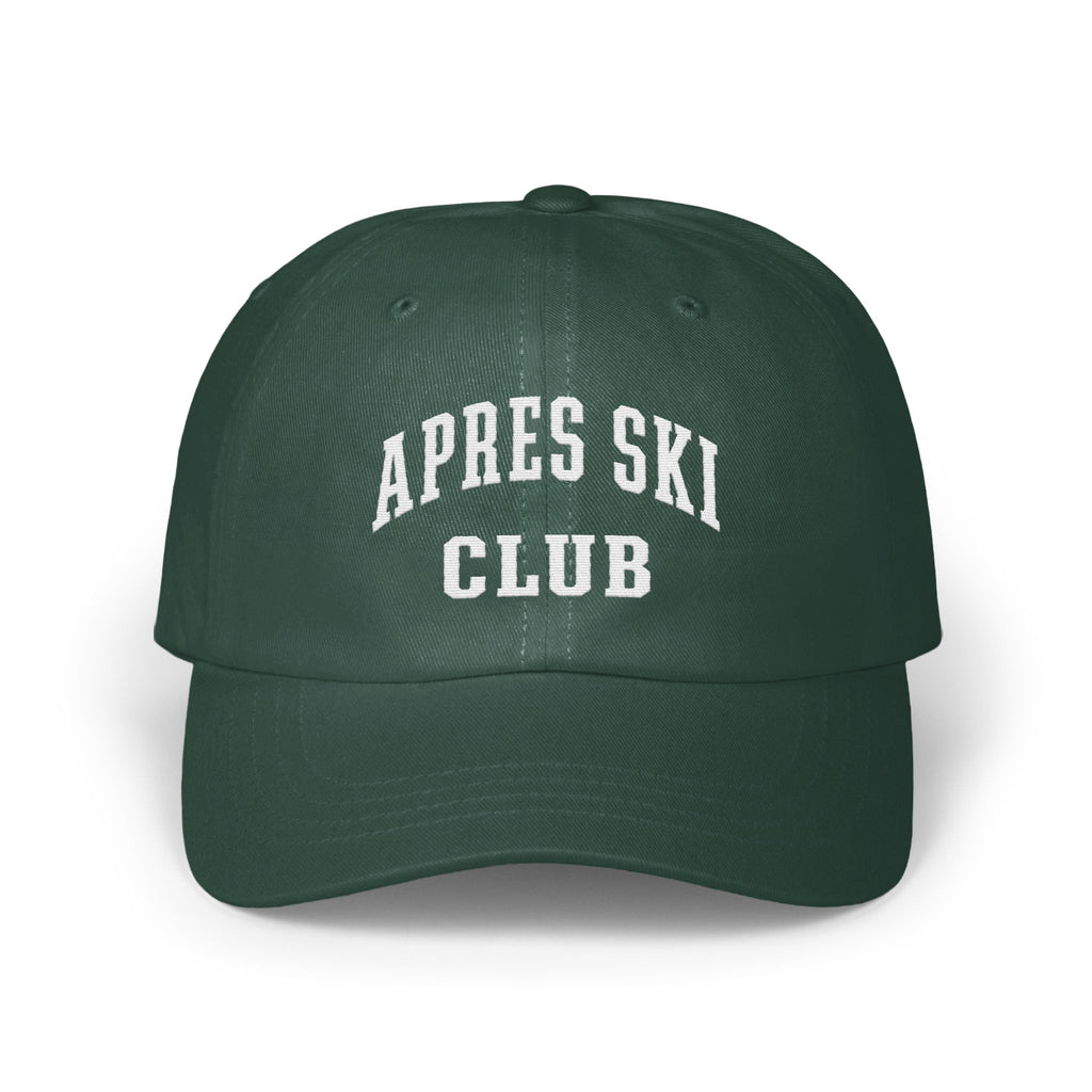 A dark green baseball cap featuring the white embroidered text APRES SKI CLUB across the front.