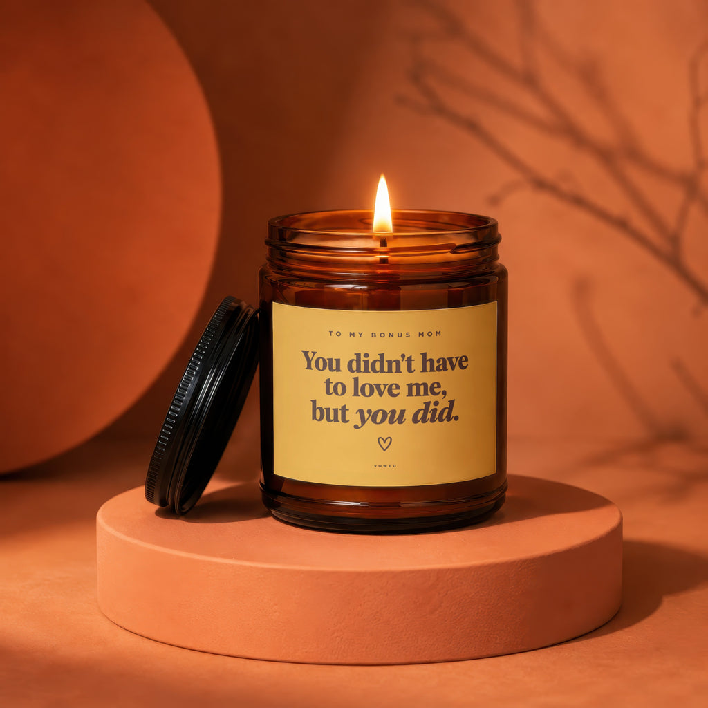 Amber jar candle with lit flame, reads "You didn't have to love me, but you did."