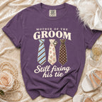 Purple t-shirt with "Mother of the Groom Still Fixing His Tie" and three ties.
