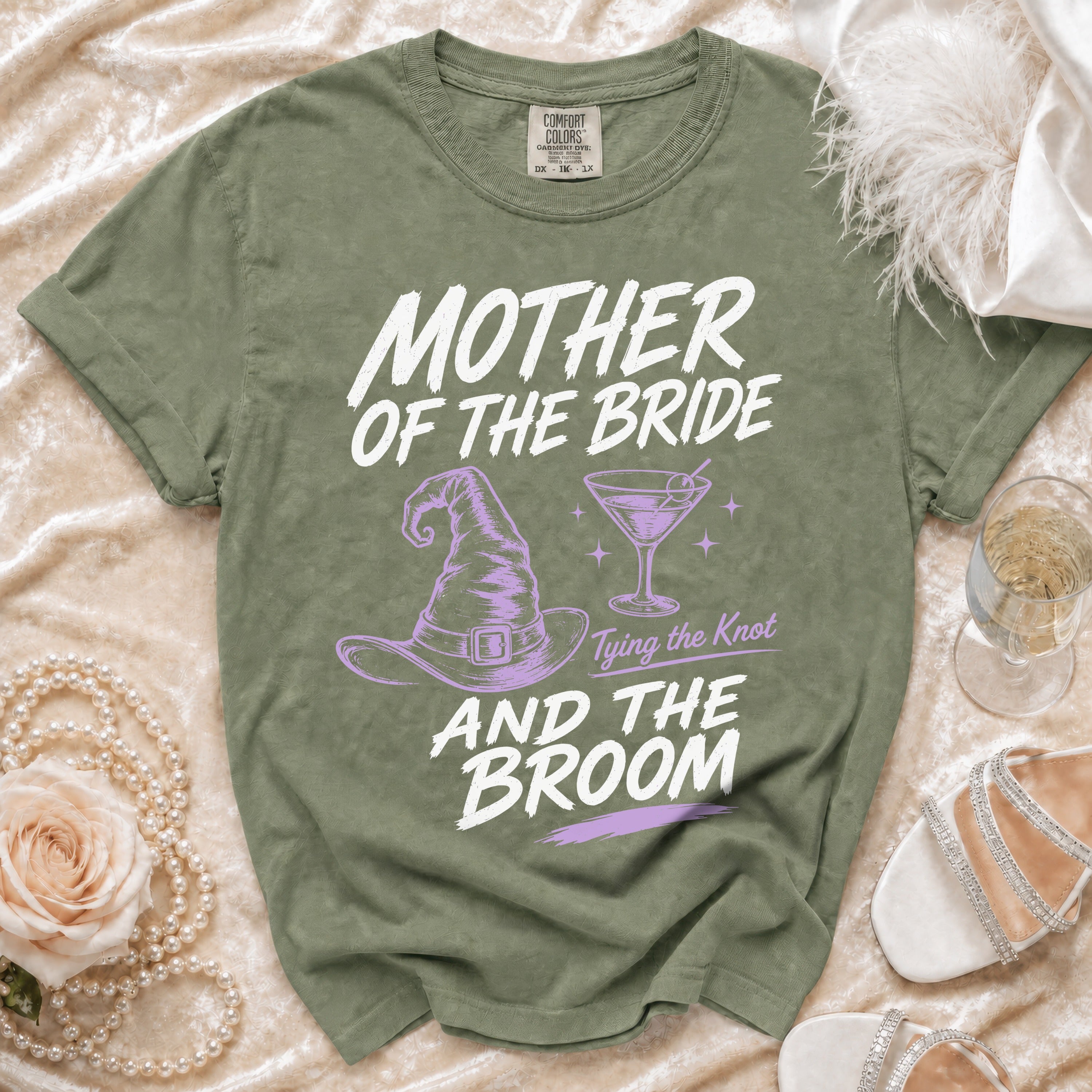 Green t-shirt with "Mother of the Bride" and "And the Broom" graphics.