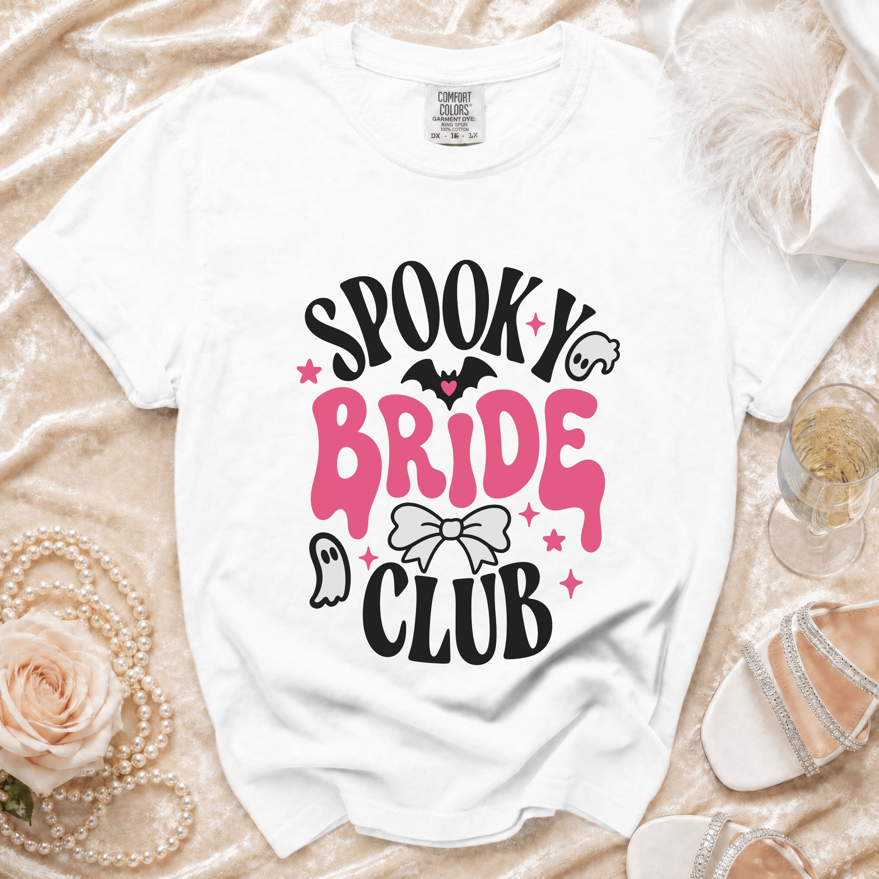 White t-shirt with "Spooky Bride Club" graphic, bat, ghost, and bow.