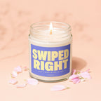 Lit candle in a glass jar with a purple label that says SWIPED RIGHT BEST DECISION EVER VOWED.