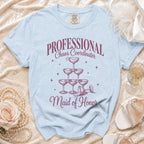 Light blue t-shirt with "PROFESSIONAL Chaos Coordinator Maid of Honor" text and champagne glasses graphic.