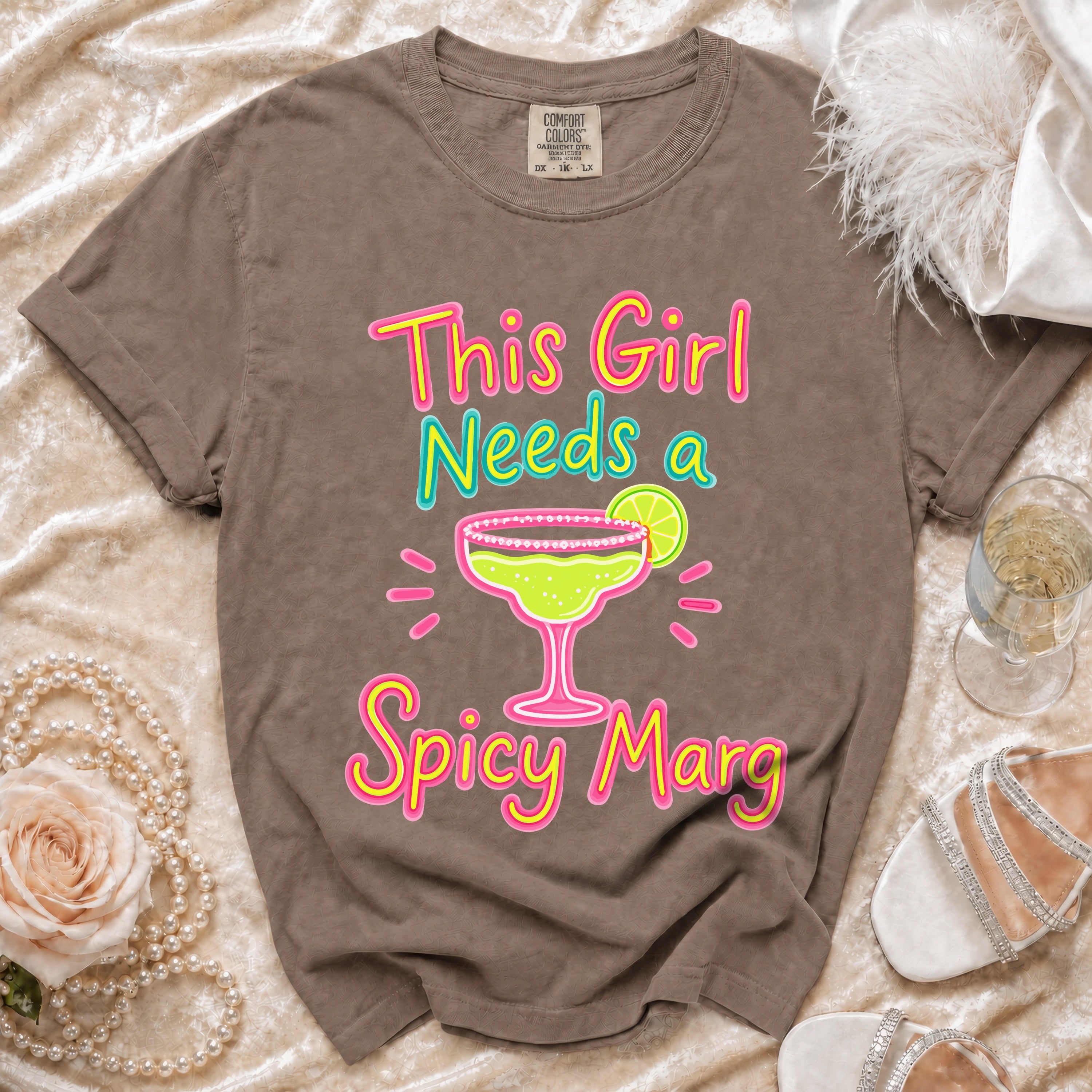 Brown t-shirt with "This Girl Needs a Spicy Marg" and margarita graphic.