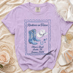 Purple t-shirt with "Reckless in Texas" and "Olivia's Bach Austin, TX Summer 2026" text.