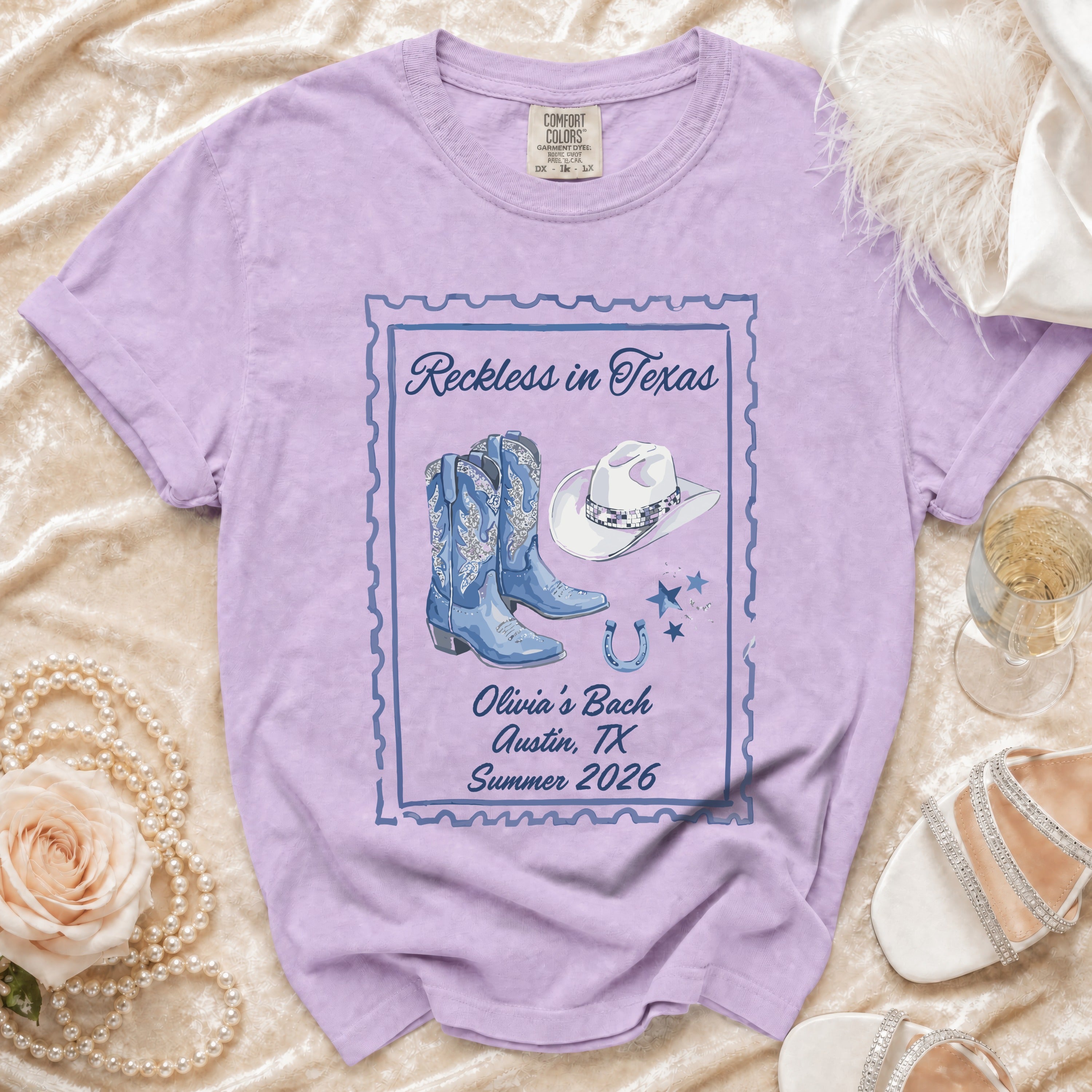 Purple t-shirt with "Reckless in Texas" and "Olivia's Bach Austin, TX Summer 2026" text.