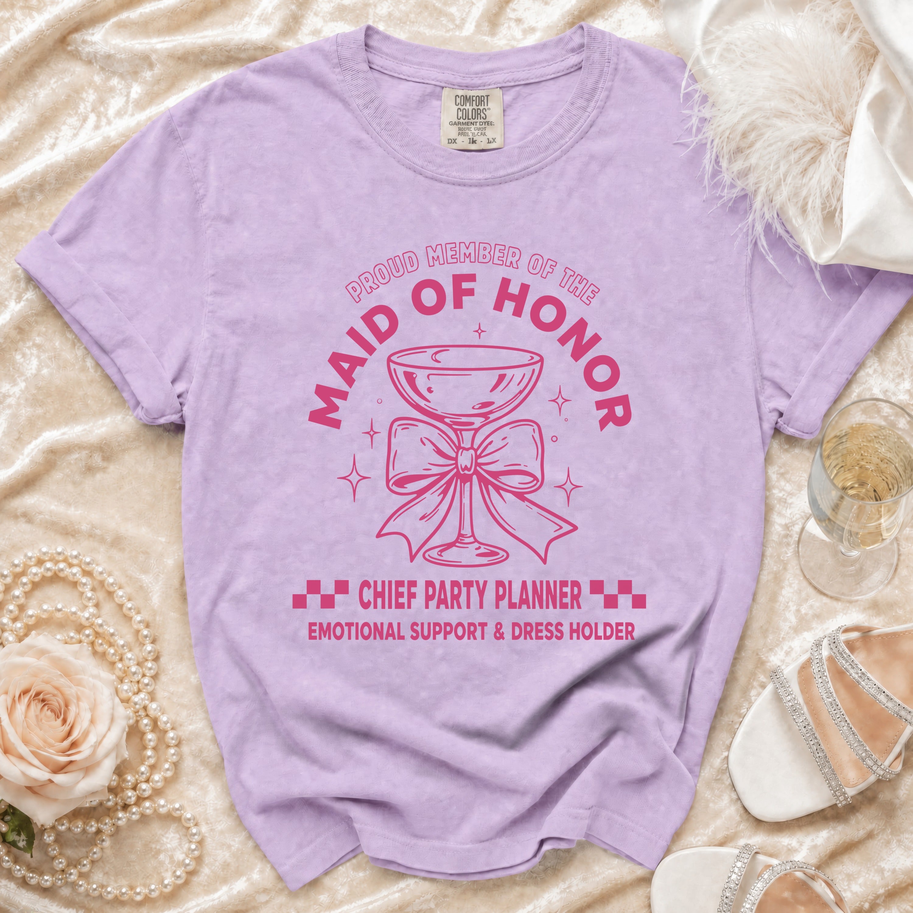 Lavender t-shirt with "Maid of Honor, Chief Party Planner" graphic and champagne glass.