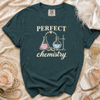 Dark teal t-shirt with "PERFECT chemistry" text and chemistry beaker graphics.