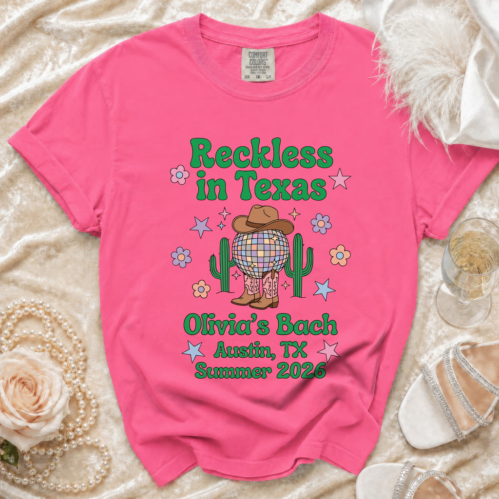 Pink t-shirt with "Reckless in Texas" and "Olivia's Bach Austin, TX Summer 2026".