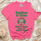 Pink t-shirt with "Reckless in Texas" and "Olivia's Bach Austin, TX Summer 2026".